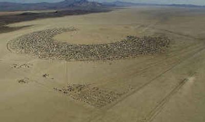 
The Black Rock City, seen in this aerial photograph, becomes Nevada's seventh-largest city for the time it is in place during the Burning Man festival. 
 (Associated Press / The Spokesman-Review)