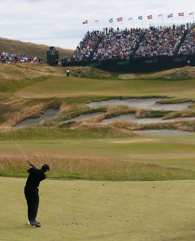 Even the grandstand views seem distant as Tiger Woods watches his tee shot on the ninth hole on Thursday. Woods opened with a 10-over-par 80. (Associated Press)