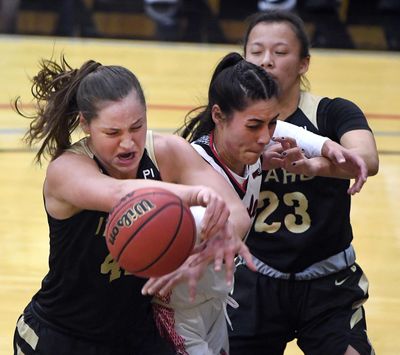 Idaho forward Natalie Klinker, left wrestles the ball away from Eastern Washington center Bella Cravens during the first half of a college basketball game, Thursday, Feb. 13, 2020, in Cheney, Wash. (Colin Mulvany / The Spokesman-Review)