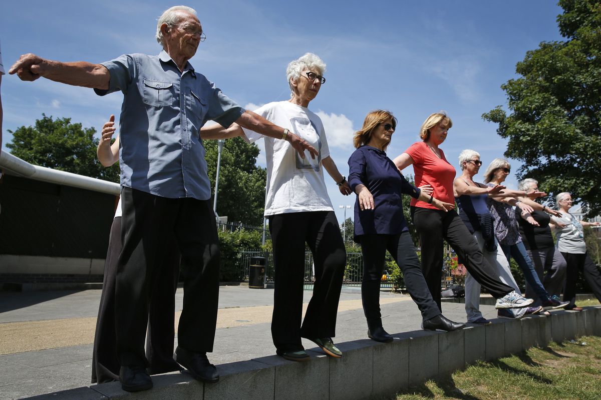 George Jackson, 85, left, an army veteran and former boxer, Lara Thomson 79, second from left, and others participate in the parkour class.