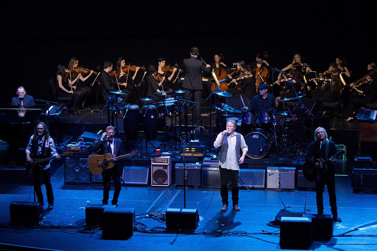 This image released by New York University shows the NYU Steinhardt orchestral string ensemble performing with members of the Eagles, foreground from left, Timothy B. Schmit, Glenn Frey, Don Henley and Joe Walsh at the Inaugural Vision Award Gala, Thursday, Nov. 15, 2012 in New York. (Mathieu Asselin / New York University)