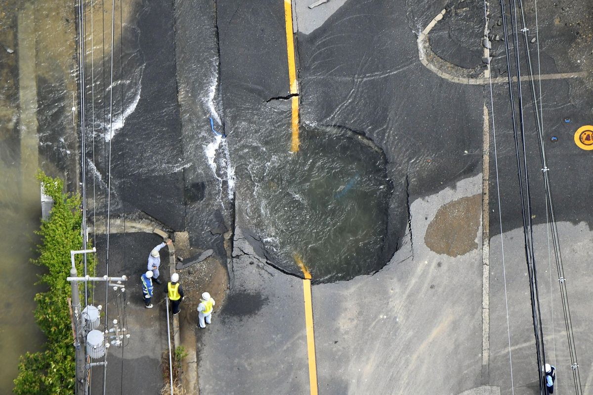 Water floods out from crack in the road, following an earthquake in Takatsuki, Osaka, Monday, June 18, 2018. A strong earthquake knocked over walls and set off scattered fires around the city of Osaka in western Japan on Monday morning. (Yohei Nishimura / Kyodo News)