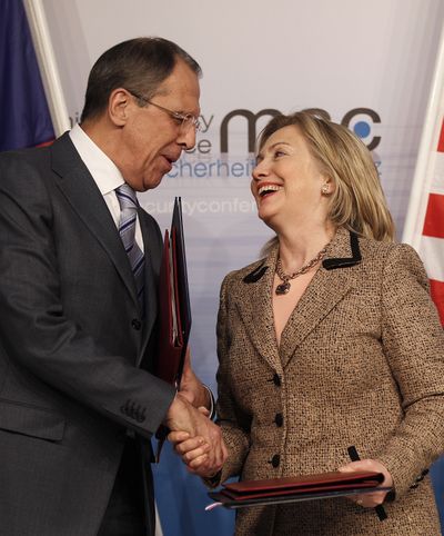 U.S. Secretary of State Hillary Rodham Clinton and Russia’s Foreign Minister Sergey Lavrov shake in Germany on Saturday. (Associated Press)