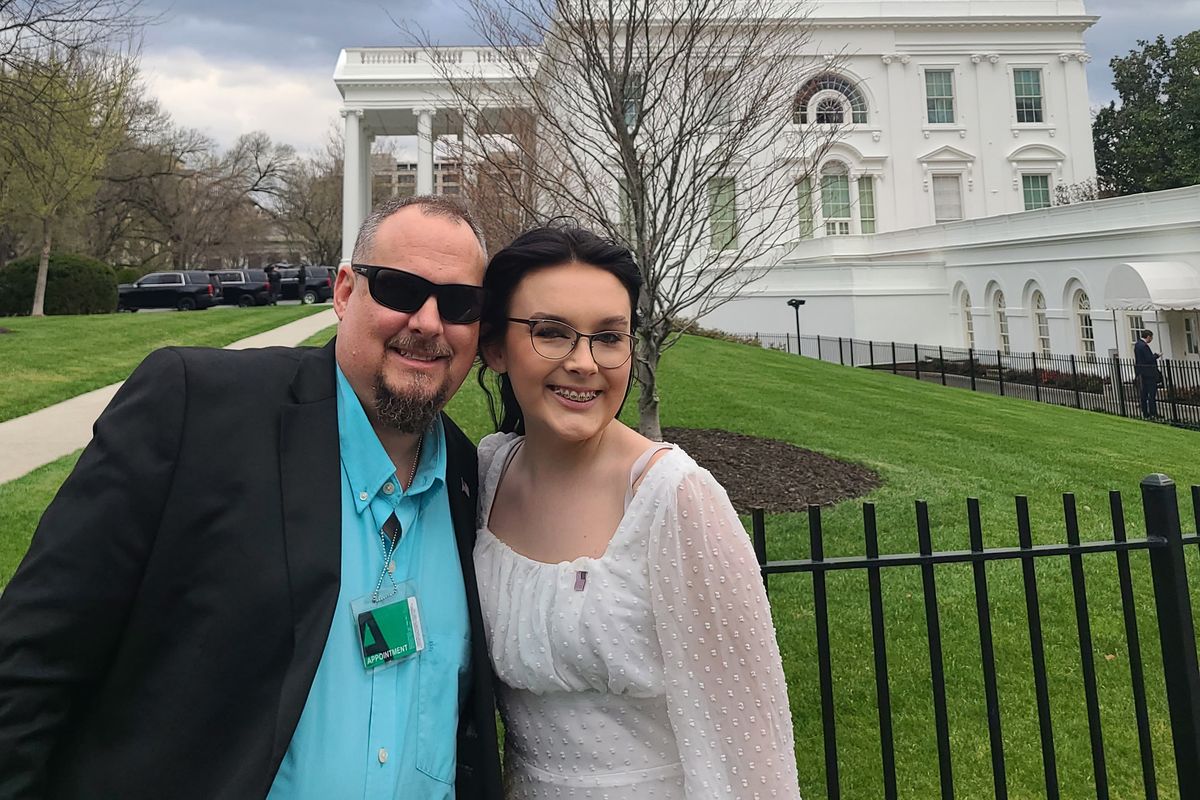 In a photo provided by Jeff Walker, he and his daughter Harleigh of Auburn, Ala., stand outside the White House on March 31, 2022, where they were guests for Transgender Day of Visibility. The family is fighting legislation in Alabama that would outlaw puberty blockers and hormone treatments for trans youth under 19.  (HONS)