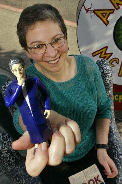 
Seattle librarian Nancy Pearl holds the librarian action figure she inspired several years ago. 
 (Associated Press / The Spokesman-Review)