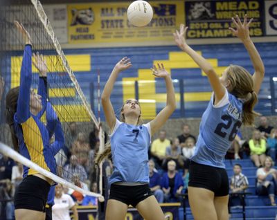 The Central Valley Bears' setter Jade Rockwood (7) puts up a short set for teammate Hannah Reiman (28) against Mead, Tuesday, Sept. 22, 2014 at Mead High School. The Bears won the five-game match. (Jesse Tinsley / The Spokesman-Review)