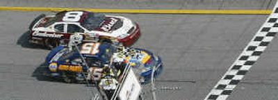 
Michael Waltrip (15) passes teammate Dale Earnhardt Jr. (8) at the finish line to win race one of the twin Gatorade Duels at Daytona International Speedway. 
 (Associated Press / The Spokesman-Review)