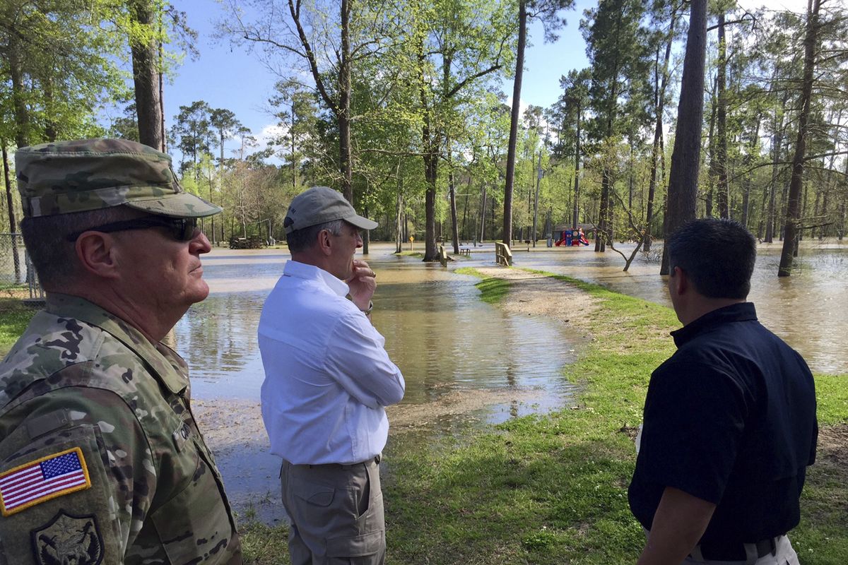 FILE - In this March 13, 2016, file photo provided by Louisiana State Police, Louisiana Gov. John Bel Edwards surveys floods in Vinton, La. At least half a dozen U.S. governors, all Democrats, are heading to the U.N. climate conference in Glasgow, Scotland, to tout their state