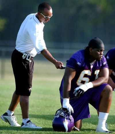 
Minnesota Vikings team physician Anthony Sanchez uses a hand-held scanner to take lineman Shannon Snell's temperature during afternoon practice. 
 (Associated Press / The Spokesman-Review)