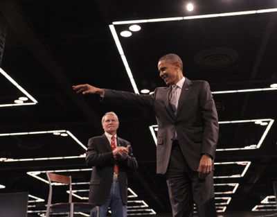 President Barack Obama waves as he arrives for a rally for Oregon gubernatorial candidate John Kitzhaber, left, at the Oregon Convention Center  Wednesday.  (Associated Press)