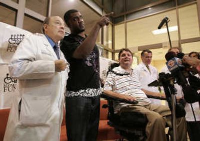 
Former Buffalo Bills tight end Kevin Everett, center, speaks to Dr. Barth Green, left, as Marc Buoniconti looks on from his wheelchair. Associated Press
 (Associated Press / The Spokesman-Review)
