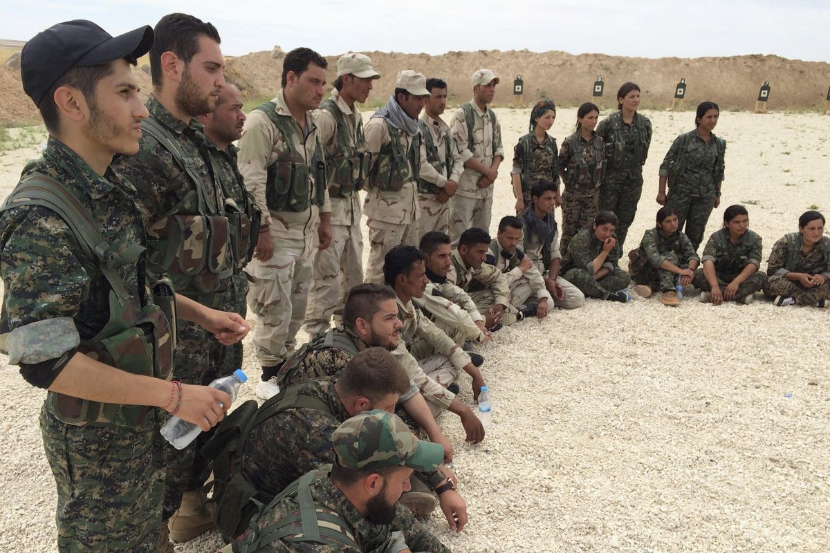 In this May 21, 2016, file photo, members of the Syrian Democratic Forces gather after a training session at a firing range in northern Syria. (Robert Burns / Associated Press)