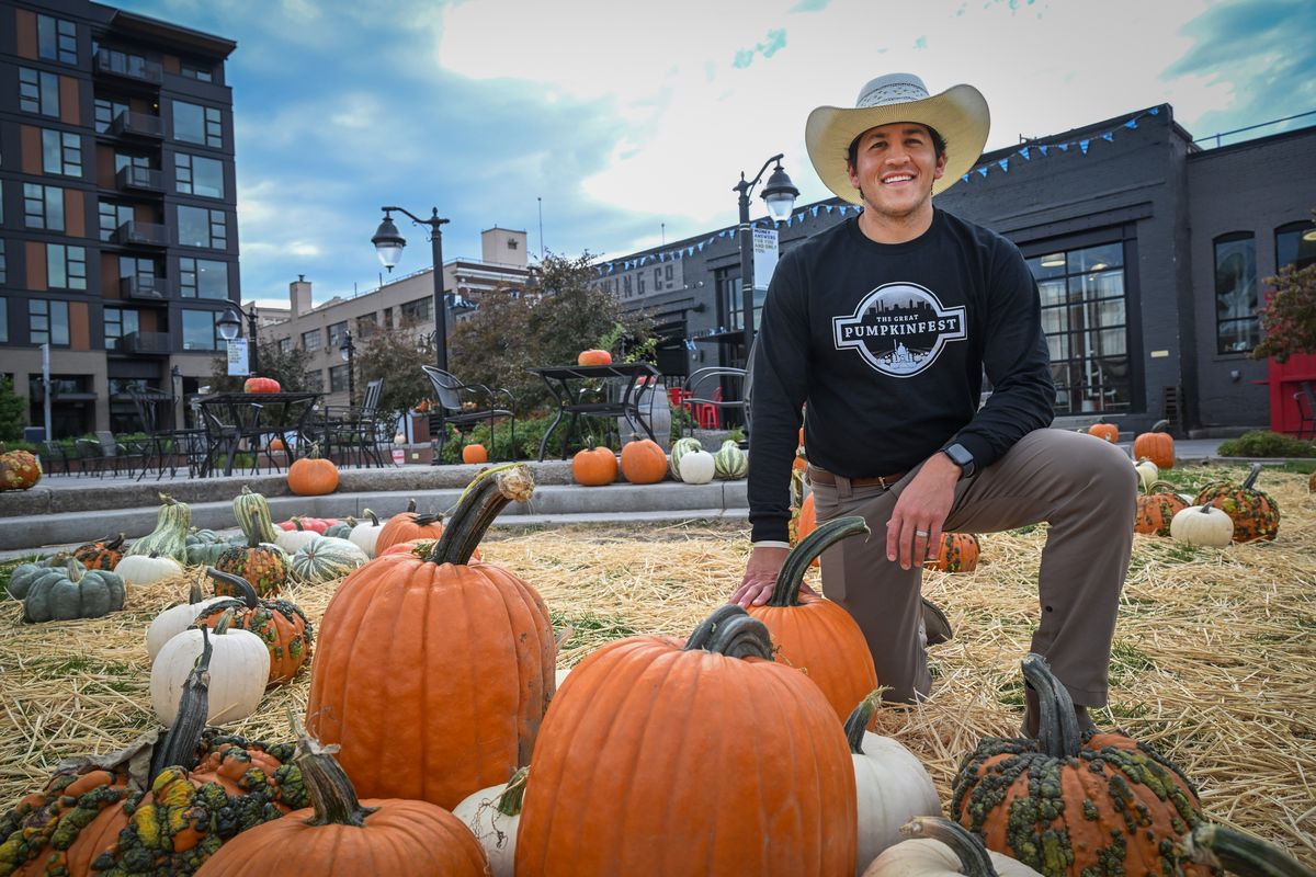 Joshua Loera, who family raises pumpkins near Moses Lake, poses Wednesday with the pumpkins he delivered to an annual event at Brick West Brewing in downtown Spokane. The open area outside the brewery is filled with pumpkins, and more will be added so they can be sold to raise money for charity.  (Jesse Tinsley/THE SPOKESMAN-REVIEW)