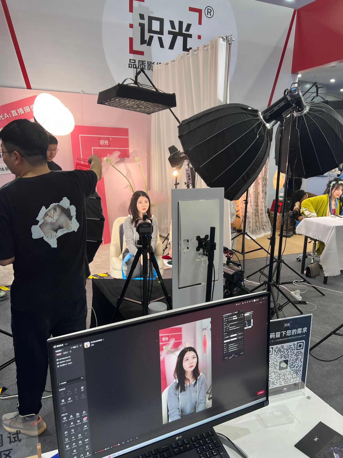 LEFT: A customer tries out live-streaming lighting at a trade fair March 20 in Shenzhen for online retailers looking to sell overseas. RIGHT: A sales rep for an online retail vendor that specializes in bubble machine toys demonstrates one of his top-selling items at a trade fair in Shenzhen in March. (Christian Shepherd/The Washington Post)