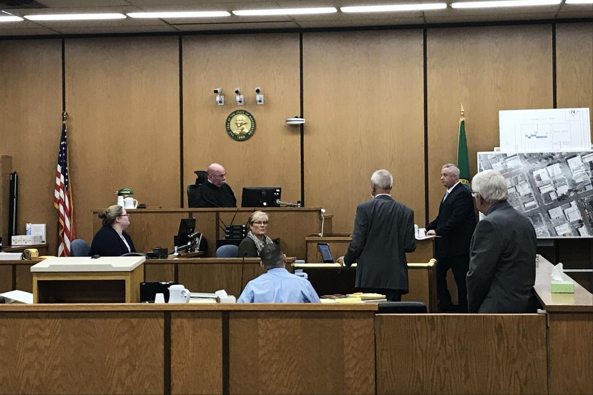 Yakima County Deputy Prosecutor Brian Aaron and Yakima Police Detective Drew Shaw prepare the courtroom to show a nine-minute video depicting the minutes leading up to the killings of Karina Morales-Rodriguez, 27, and Marta Martinez, 30, during trial proceedings on Monday. (Kaitlin Bain / Yakima Herald-Republic)