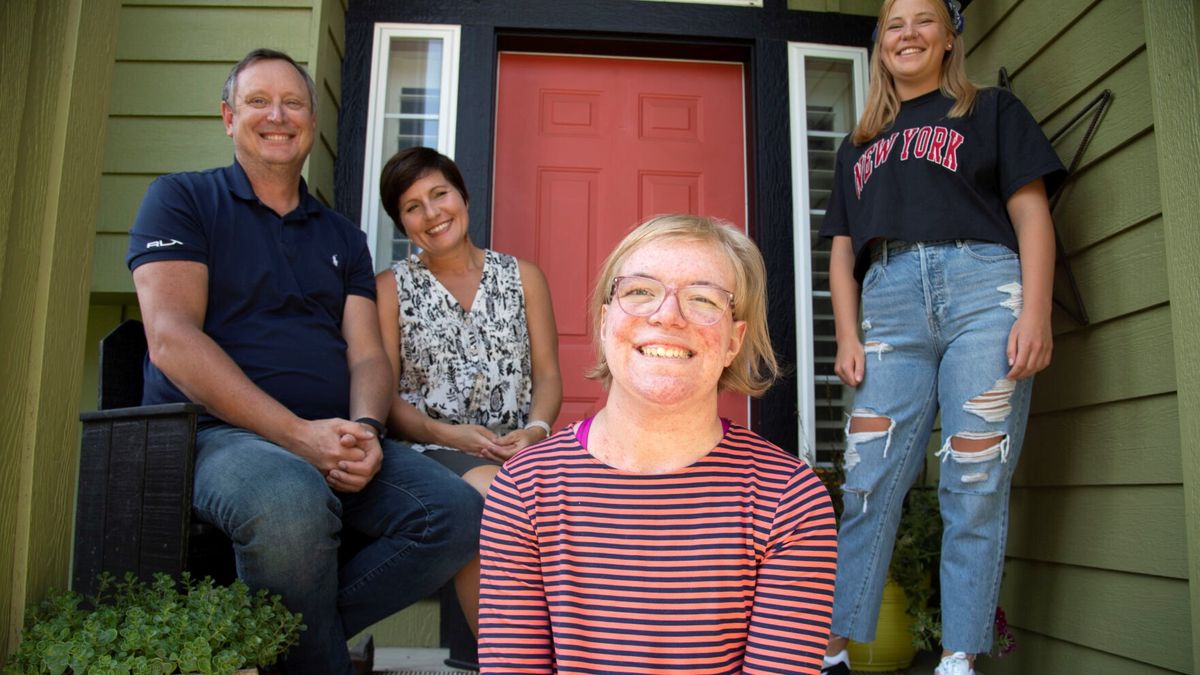 Grace Carney, 18, foreground, sits with her parents, Chris and Janet, and sister, Gillian, at their Spokane home on July 31. Grace suffers from neurofibromatosis, a genetic disorder that causes tumors to grow all over the body, including one that had wrapped around her spine and caused pain and threat of paralysis. A new drug has shrunk her tumors instead of her having to face a dangerous, complex surgery. (Jesse Tinsley/The Spokesman-Review)