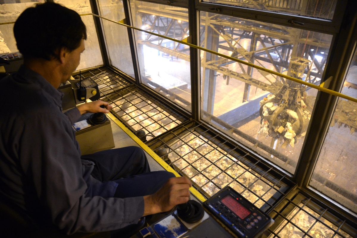 Crane operator Eric Vangemert watches as the grapple of his crane picks up tons of garbage at a time to feed the fires of the Waste-to-Energy Plant, Tuesday, Jan. 5, 2016. The plant, operated by the city of Spokane, burns much of the garbage produced locally. (Jesse Tinsley / The Spokesman-Review)