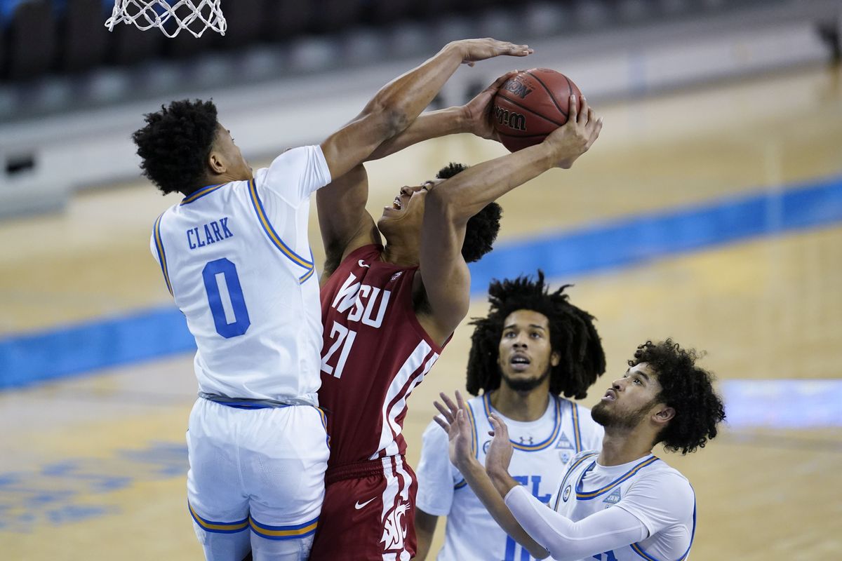 UCLA guard Jaylen Clark challenges a shot attempt by Washington State center Dishon Jackson on Thursday afternoon in Los Angeles. Jackson, a freshman, hit both of his shots from the field and finished with 8 points.  (Associated Press)