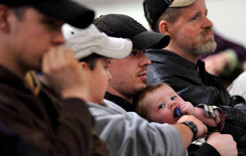 Lucky Friday miner, Brad Sala, of Mullan holds his 8 month-old-son Cael Sala during the press conference at Mullan City Hall on Saturday, April 17, 2011. One miner is still trapped in the mine after a cave in. (Kathy Plonka / The Spokesman-Review)