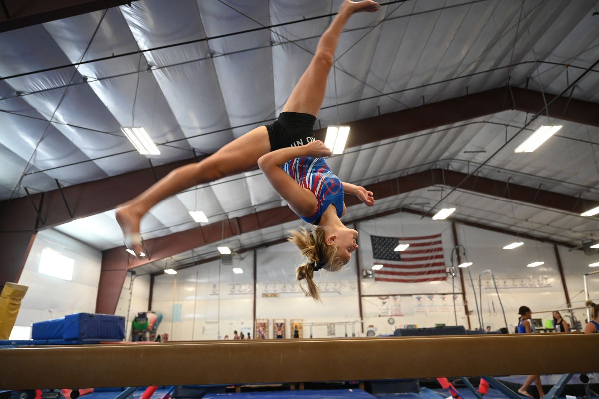 Maddy Murphy, 16, performs a challenging move on the balance beam Thursday  (Jesse Tinsley/THE SPOKESMAN-REVIEW)