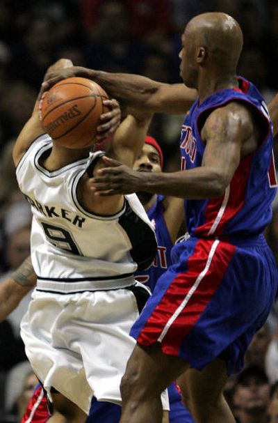 
Detroit's Chauncey Billups gets a hand on the ball as  the Spurs' Tony Parker, left, works the ball to the goal in the first quarter in Game 1 of the Finals. 
 (Associated Press / The Spokesman-Review)