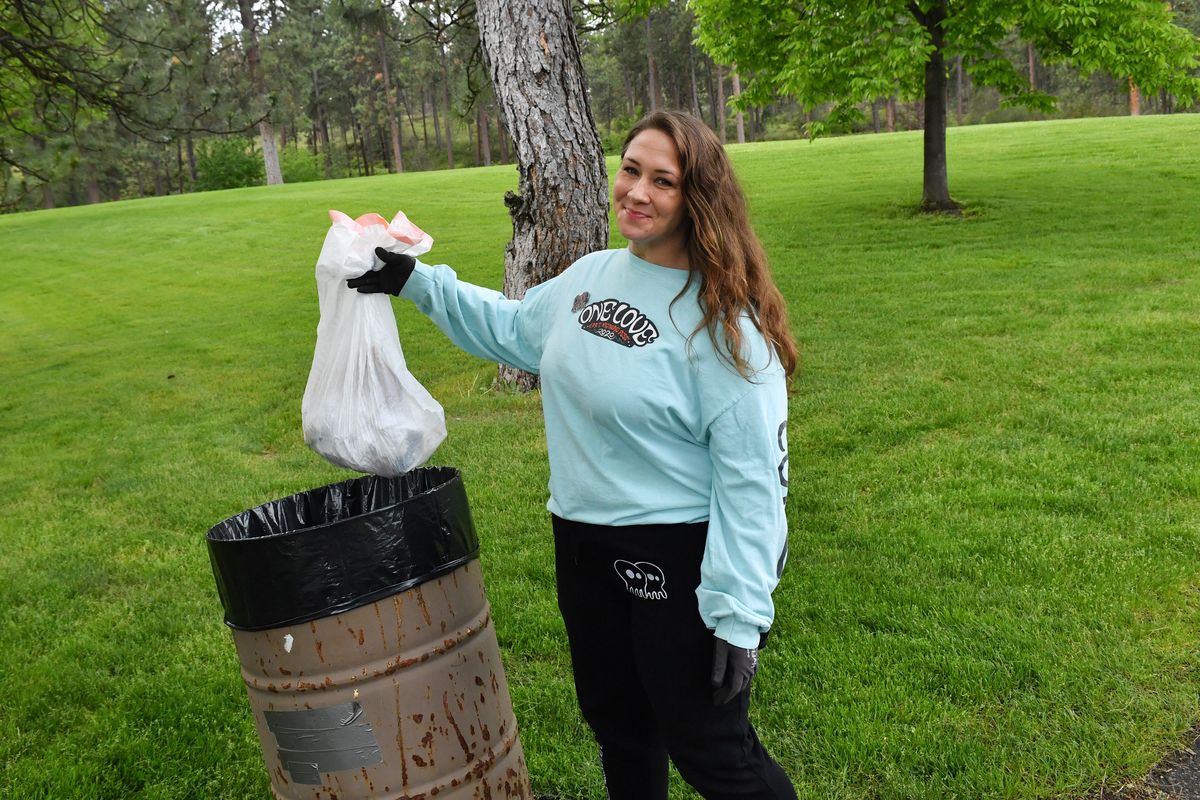 Kim Carr with the local group, 509 Rocks, poses for a photo before throwing out garbage she collected June 8 at Mirabeau Meadows Park in Spokane Valley.  (Tyler Tjomsland/The Spokesman-Review)