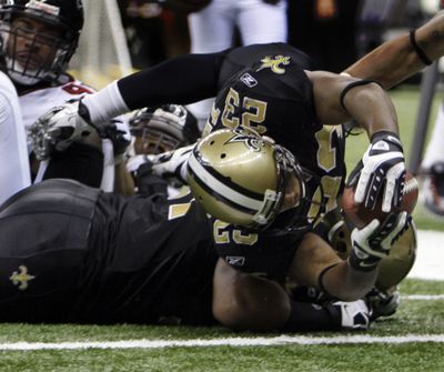 Saints running back Pierre Thomas stretches for the goal line to score in the second half of Sunday’s win over Atlanta. (Associated Press / The Spokesman-Review)