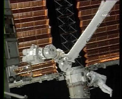 
In this image from NASA TV, mission specialist Steve Swanson is shown working on the retraction of the starboard solar array on the International Space Station on Wednesday. Associated Press
 (Associated Press / The Spokesman-Review)