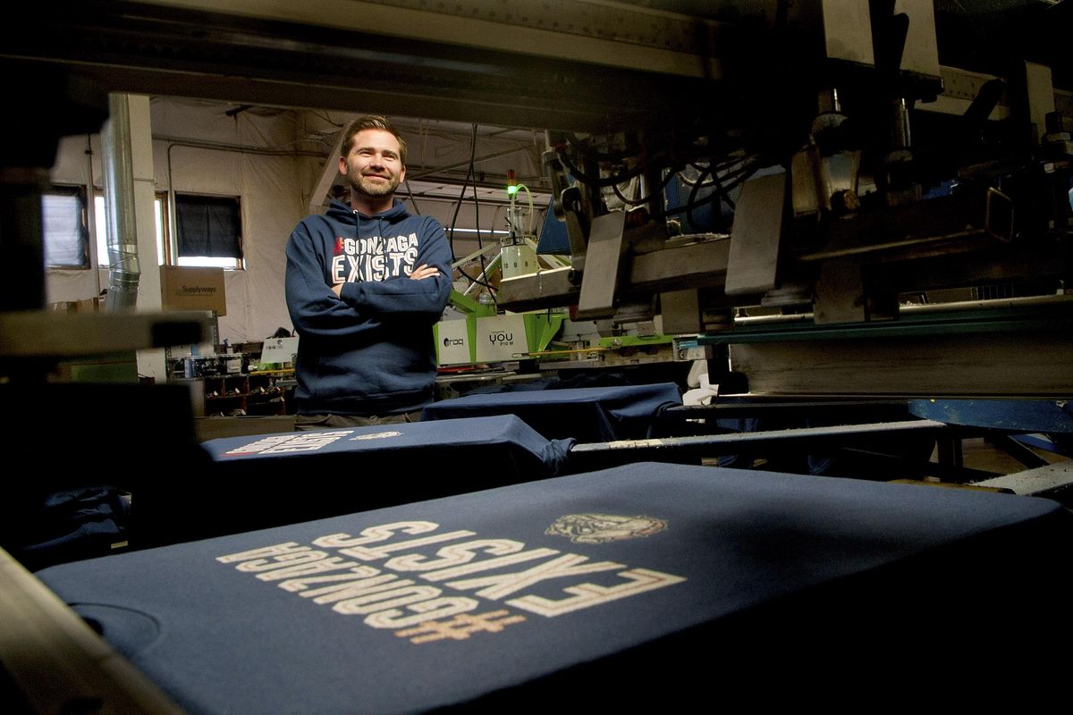 Brayden Jessen, founder and co-owner of Zome Design is photographed at his shop in Spokane Valley on Friday, March 29, 2019. Zome Design is the company that created the #GONZAGA EXISTS apparel. (Kathy Plonka / The Spokesman-Review)