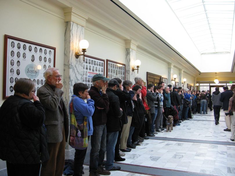 Solemn backers of legislation to protect gays from discrimination stand in a statehouse hallway in silent protest after the bill was killed on a party-line vote (Betsy Russell)