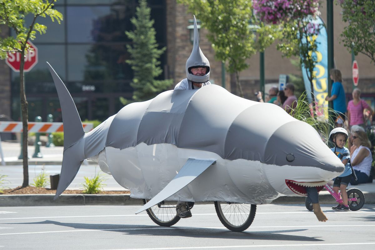 Ross Welburn, of Hayden, rides his shark cycle Sunday in the parade at Kinetic Fest, a celebration of moving sculpture and human-powered transportation at the Riverstone development in Coeur d’Alene. Welburn created the frame from wood and plastic pipe. (Jesse Tinsley)
