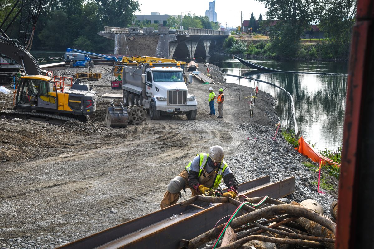 Work continues on the historic East Trent Bridge demolition site where two spans have been removed, Thursday, Aug. 13, 2020, in Spokane. The concrete bridge was built in 1910 with Luten arch style to replace a wooden structure. Work will last until fall of 2023.  (DAN PELLE/THE SPOKESMAN-REVIEW)