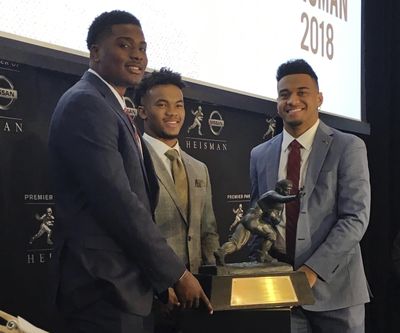 Heisman Trophy finalists, from left, Dwayne Haskins of Ohio State, Kyler Murray of Oklahoma and Tua Tagovailoa of Alabama pose with the Heisman Trophy at the New York Stock Exchange on Friday, Dec. 7. (Ralph Russo / AP)
