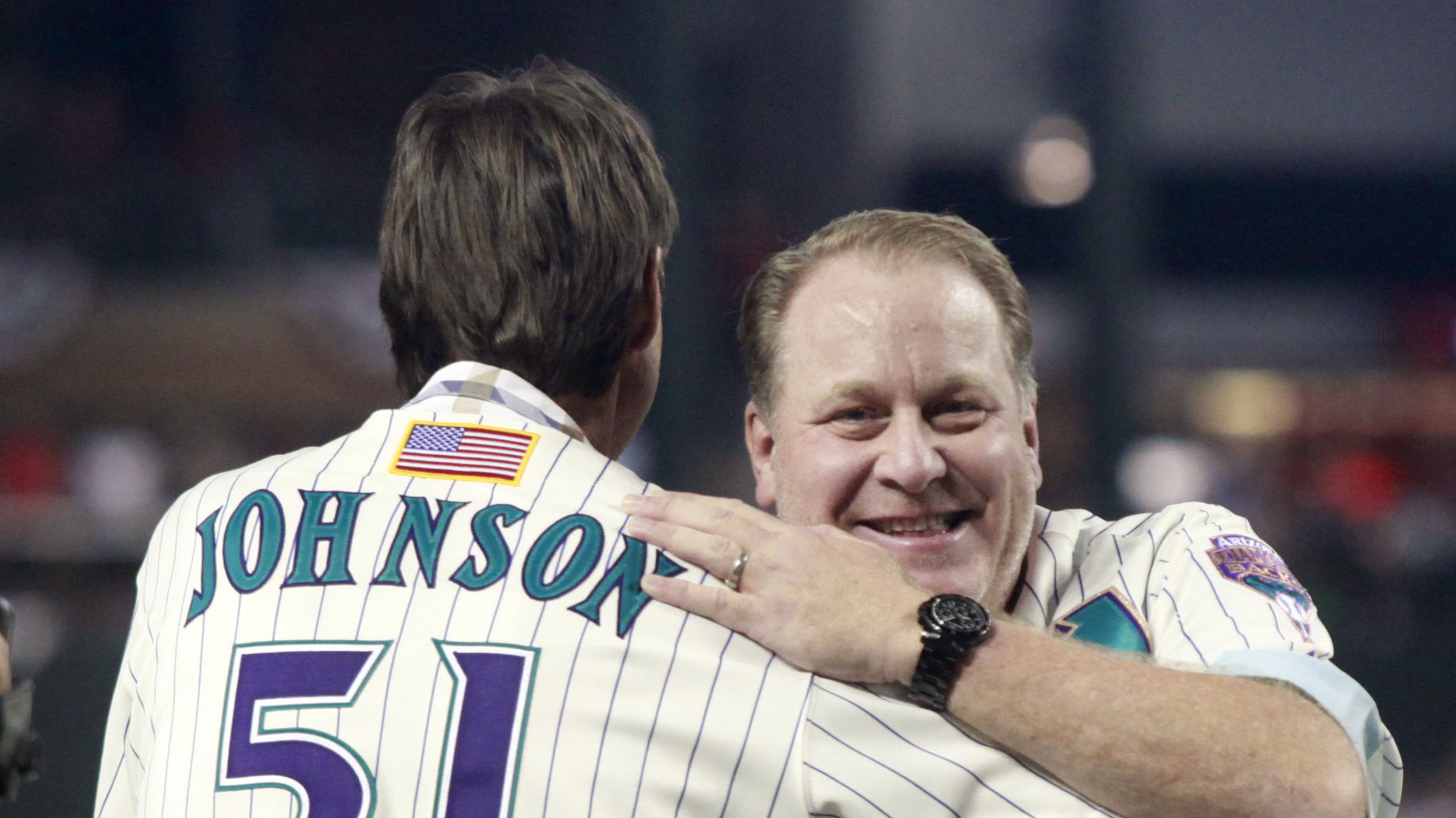 Arizona Diamondbacks owner Jerry Colangelo, left, presents pitcher