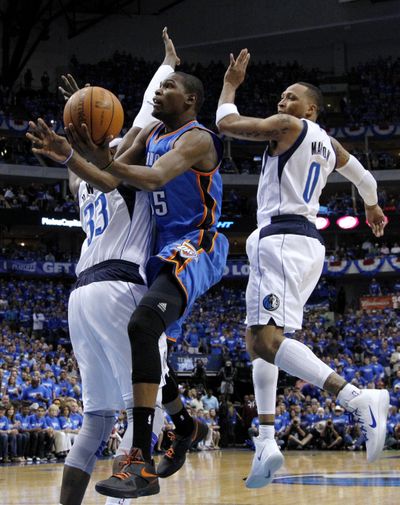 Mavericks’ Brendan Haywood, left, and Shawn Marion defend Thunder’s Kevin Durant, who scored 31 points in Game 3 win. (Associated Press)