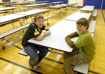 
Brady Linerud, left, sits in the cafeteria with his friend Jacob Schwinning, who alerted school cook Dee Grant  when Brady choked on a  chip during lunch last week.  
 (J. BART RAYNIAK / The Spokesman-Review)