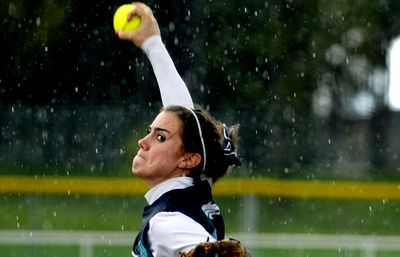 Lela Work delivers a pitch in the rain during Lake City’s game against Borah on Thursday at Ramsey Park in Coeur d’ Alene. (Kathy Plonka / The Spokesman-Review)
