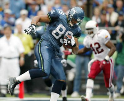 
Seattle tight end Itula Mili catches a 1-yard touchdown pass against the Arizona Cardinals in 2002. 
 (File/Associated Press / The Spokesman-Review)