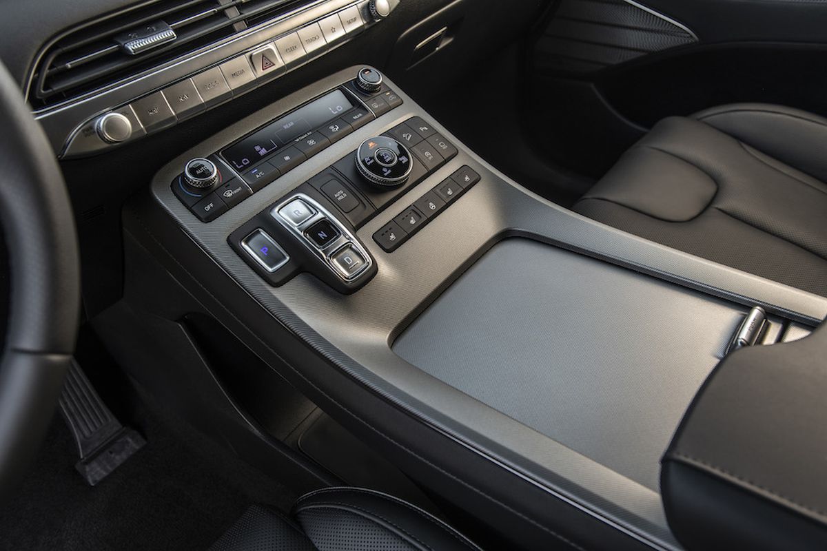 Cabin storage options include a large rubberized shelf beneath the center console and a covered bin under the console-mounted center armrest. There are cupholders everywhere, of course. (Hyundai)