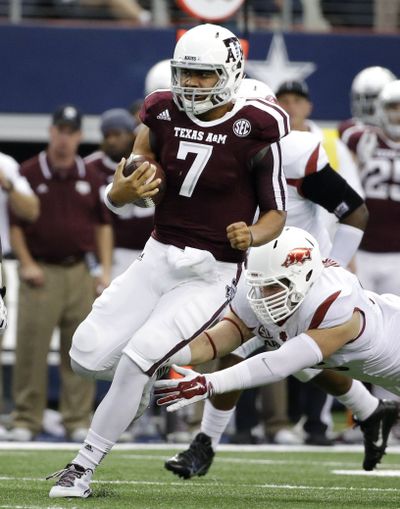 Karl Roesler, right, and Arkansas couldn’t reel in Texas A&M quarterback Kenny Hill. (Associated Press)
