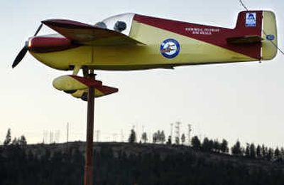 
A 19-foot long plane on a flag pole serves as a windvane next to the main terminal at Felts Field. The windvane is a memorial to pilot Robert Heale. 
 (Holly Pickett / The Spokesman-Review)