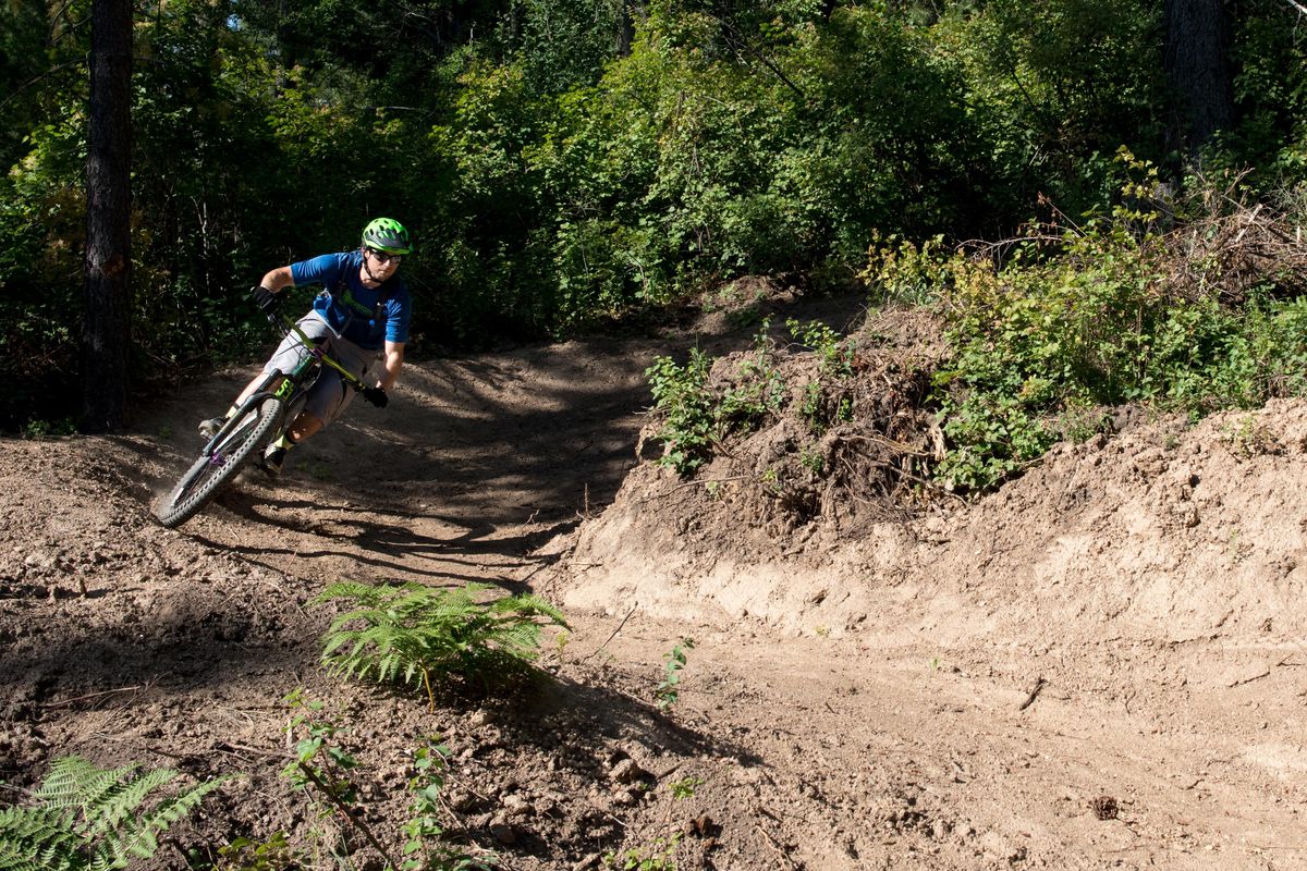 Harley Dobson rounds a corner on newly constructed mountain bike trails on Mica Peak on July 22, 2019. Some of the new routes are flow trails with banked turns allowing riders to move seamlessly down the face. ELI FRANCOVICH/THE SPOKESMAN-REVIEW. (Eli Francovich / The Spokesman-Review)