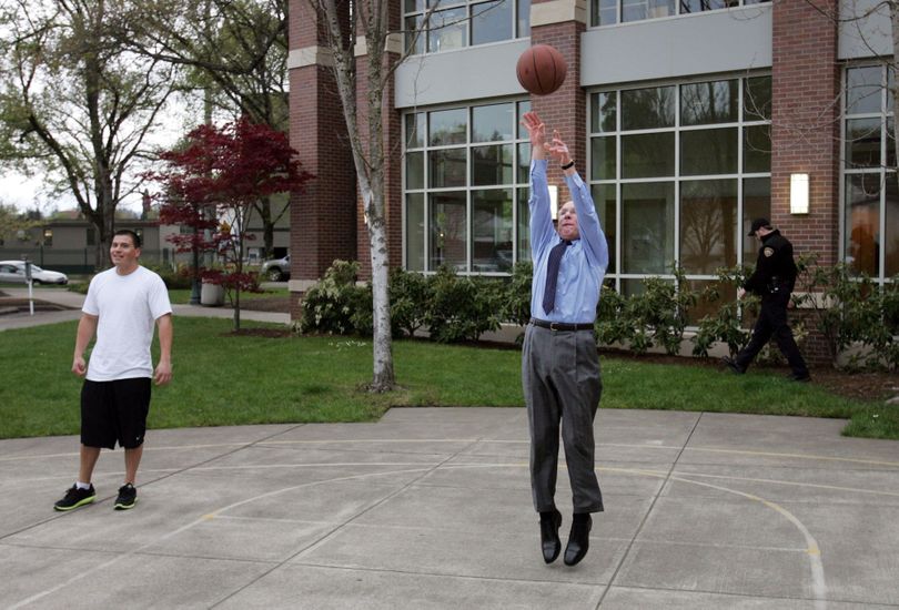 Oregon Gov. Ted Kulongoski takes a minute to shoot some hoops after leaving a conference on climate change at the Knight Law School in Eugene, Ore. Wednesday April 14, 2010. (Chris Pietsch / The Register-guard)