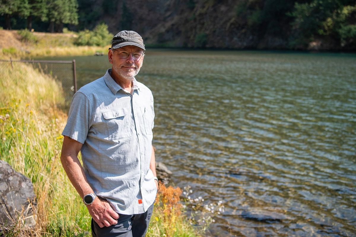 Michael Tehan, standing near Little White Salmon River on SEpt. 4, is a retiring NOAA administrator who volunteers at shorthanded hatcheries in the area.  (Taylor Balkom/The Columbian)