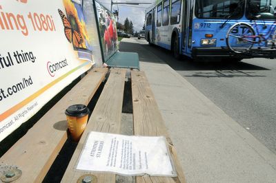 A bus stop bench on 29th Avenue near Ray Street has a sheet attached to it informing users the bench will be removed soon. The message was posted by Sunset Outdoor Advertising.  (Dan Pelle / The Spokesman-Review)