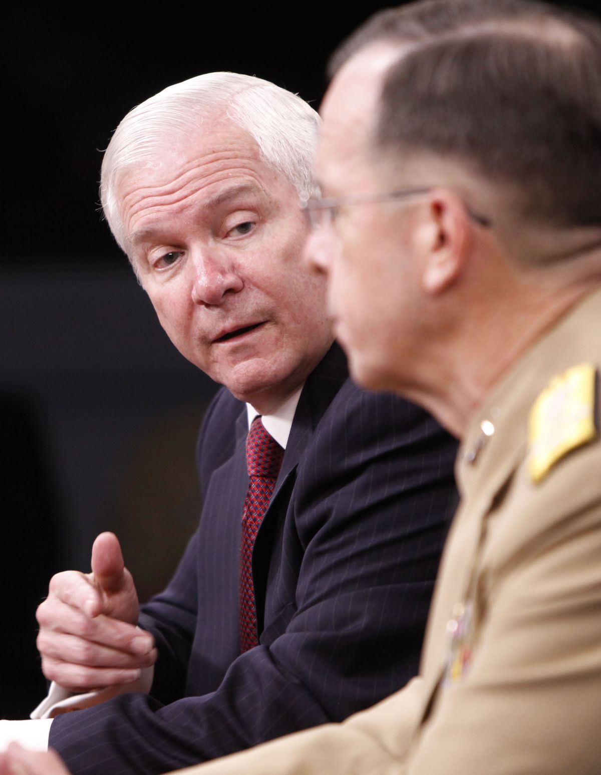 Defense Secretary Robert Gates, left, accompanied by Joint Chiefs Chairman Adm. Michael Mullen, meets reporters Monday at the Pentagon.  (Associated Press / The Spokesman-Review)