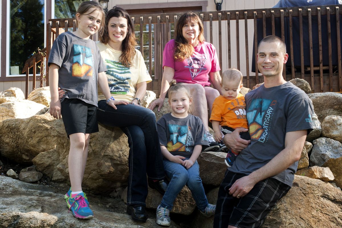 Margie Cooke, back center, has run Bloomsday since 1988. Her family, from left, Maia Siemers, 7, her mother Bethany, Megan, 5, and Jeff, holding 9-month-old Wes, pose for a photo in Spokane Valley. (Tyler Tjomsland)