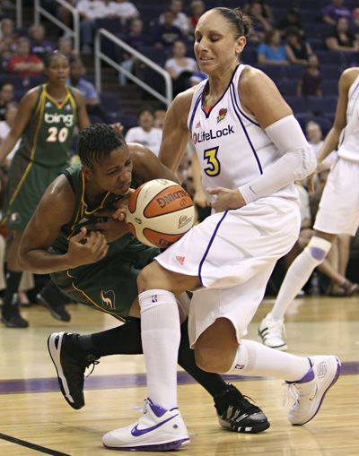 Seattle Storm guard Tanisha Wright, left, and Phoenix Mercury guard Diana Taurasi vie for the ball on Wednesday in Phoenix. (Associated Press)
