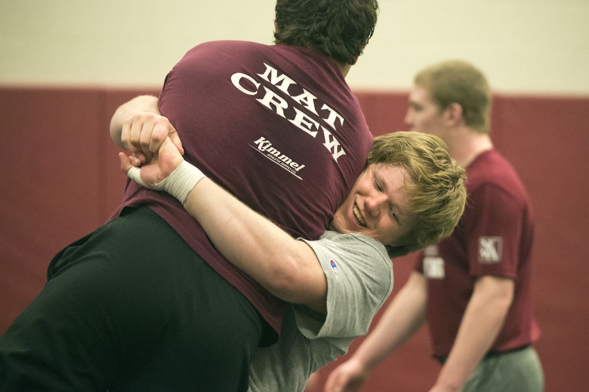 Tate Orndorff, U-Hi’s defending state champion heavyweight, practices a throw on a training partner. (Jesse Tinsley)