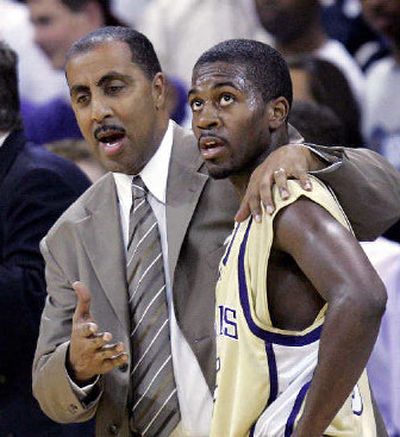 Washington coach Lorenzo Romar talks with freshmen starter Justin Dentmon.
(Associated Press / The Spokesman-Review)